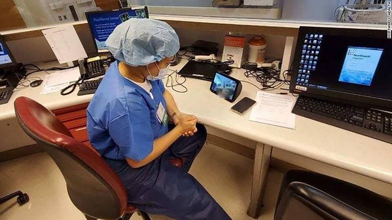 Health care worker using technology to communicate with patient.